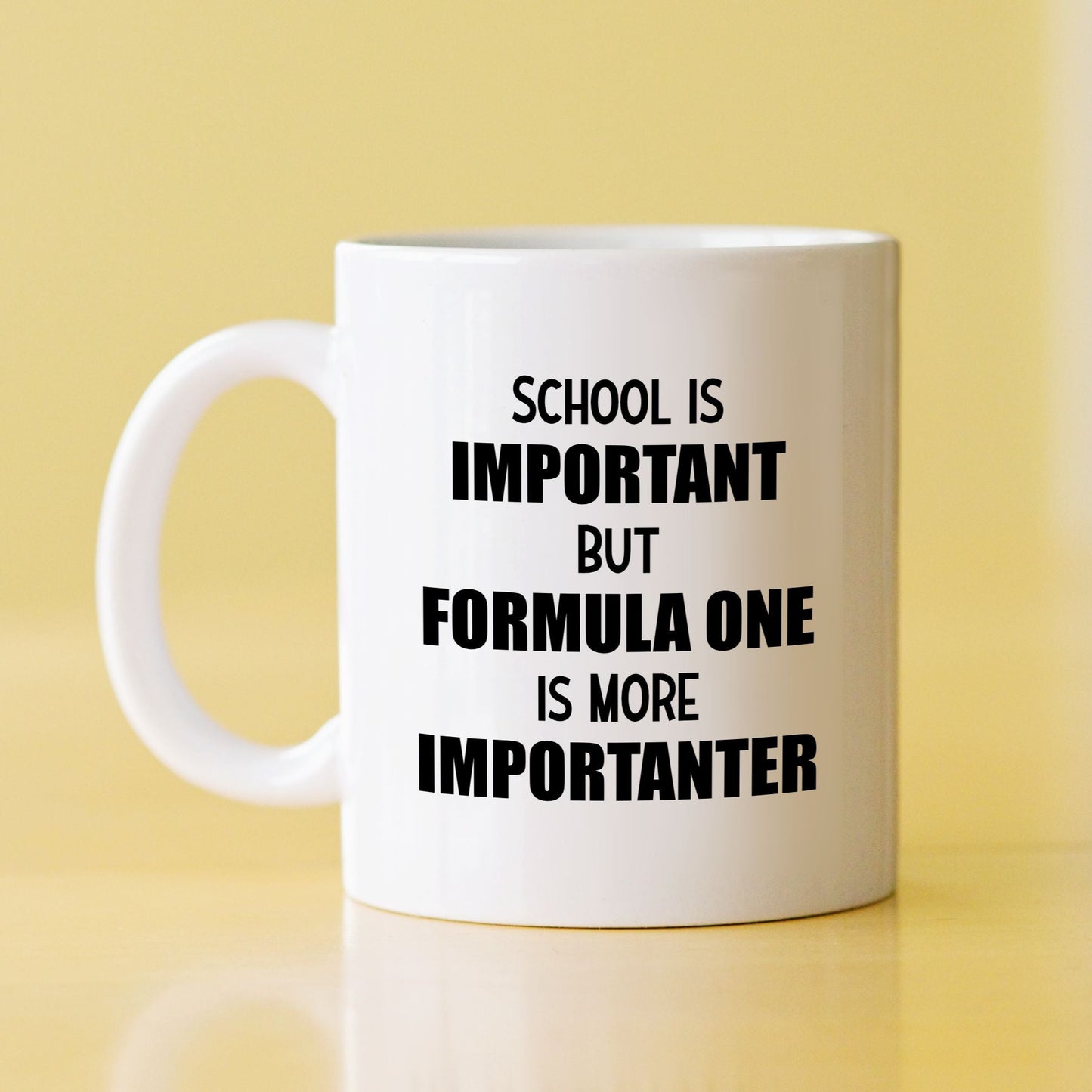 White mug with quote "School is important but Formula 1 is more Importanter"
