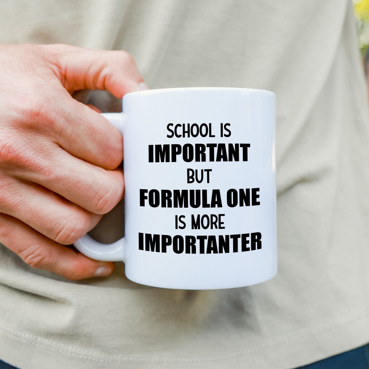 White mug with quote "School is important but Formula 1 is more Importanter"