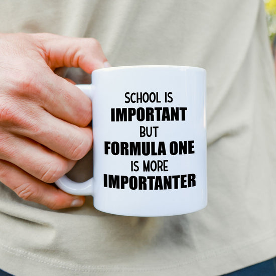 White mug with quote "School is important but Formula 1 is more Importanter"